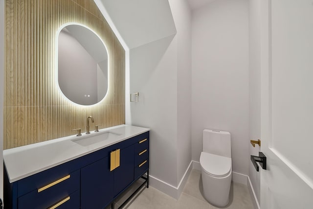 bathroom featuring tile patterned flooring, vanity, and toilet