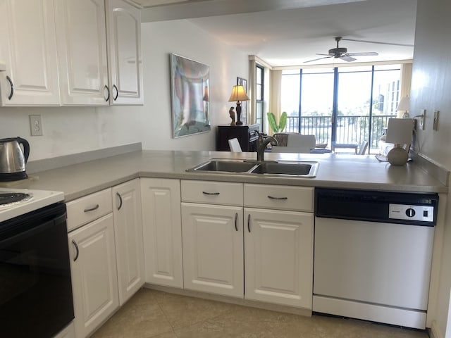 kitchen featuring dishwasher, white cabinets, and sink