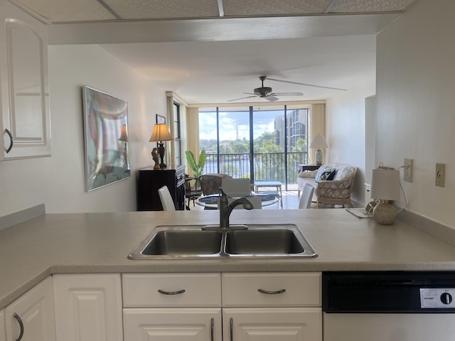 kitchen with white cabinets, dishwasher, ceiling fan, and sink