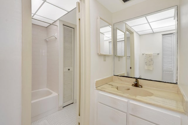 bathroom featuring tile patterned flooring, vanity, shower / washtub combination, and a paneled ceiling