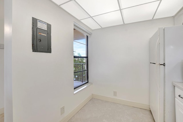 interior space featuring a paneled ceiling and electric panel