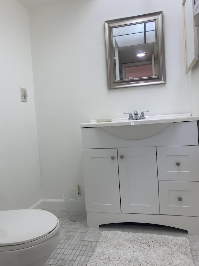 bathroom featuring tile patterned flooring, vanity, and toilet