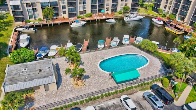 view of pool with a water view and a patio