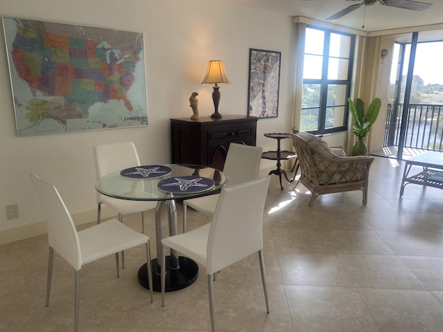 dining area with ceiling fan and light tile patterned floors