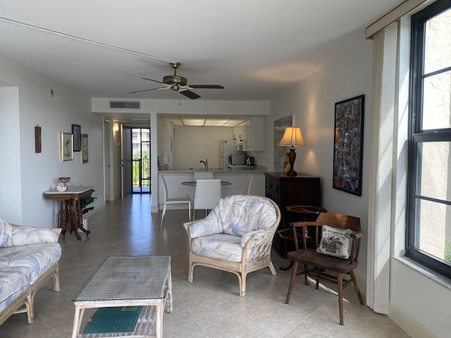 living room with sink, a wealth of natural light, and ceiling fan