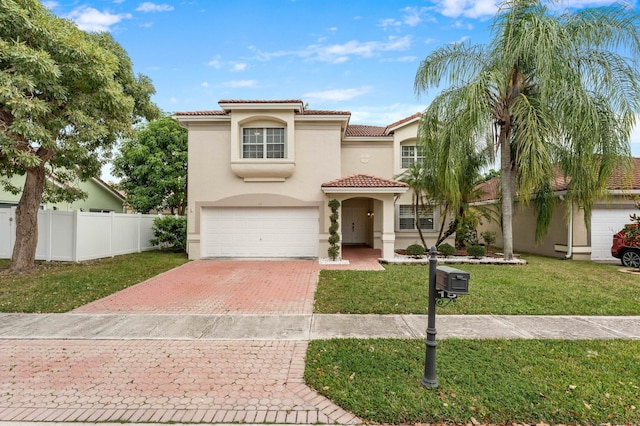 mediterranean / spanish house featuring a garage and a front lawn