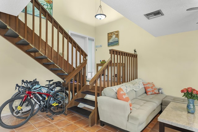 living room featuring a textured ceiling and tile patterned floors