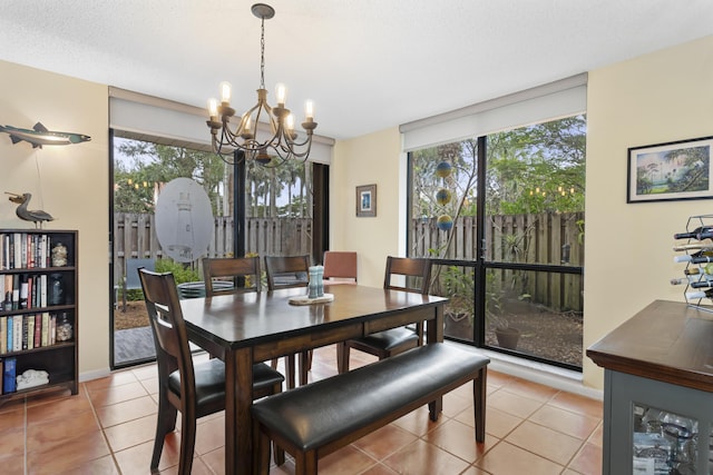 dining room with plenty of natural light, light tile patterned floors, a notable chandelier, and a textured ceiling