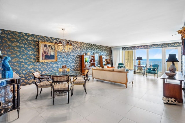 dining room with a water view, light tile patterned floors, and an inviting chandelier