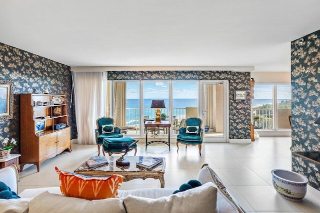 living room featuring a water view and light tile patterned floors