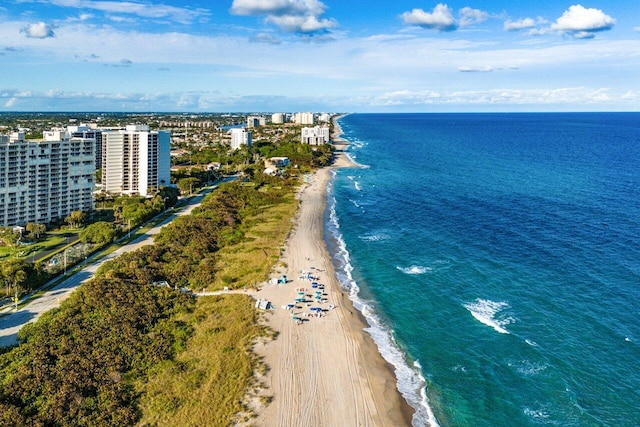 birds eye view of property with a water view and a view of the beach