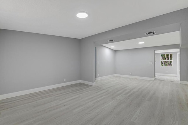 empty room with light hardwood / wood-style flooring