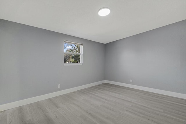 spare room with light hardwood / wood-style flooring