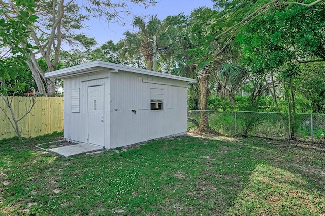 view of outbuilding with a lawn