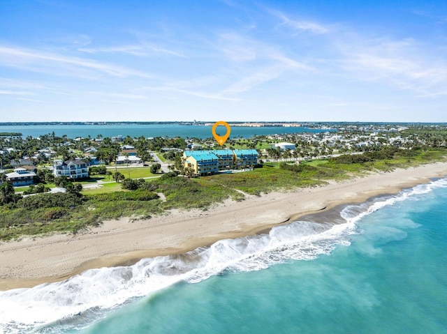 drone / aerial view with a beach view and a water view