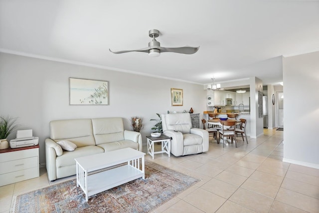 tiled living room featuring sink, ceiling fan with notable chandelier, and ornamental molding