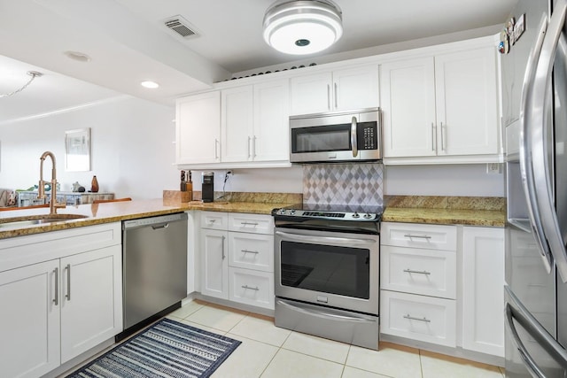 kitchen featuring stainless steel appliances, white cabinetry, and sink