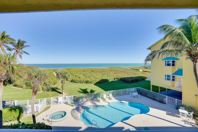 view of pool featuring a patio area, a water view, and a community hot tub