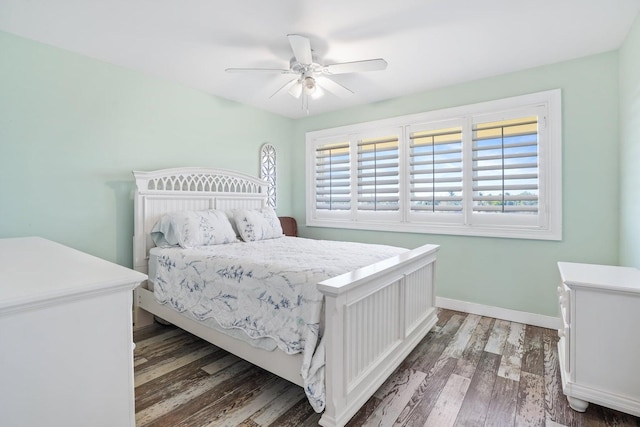 bedroom featuring multiple windows, ceiling fan, and dark wood-type flooring