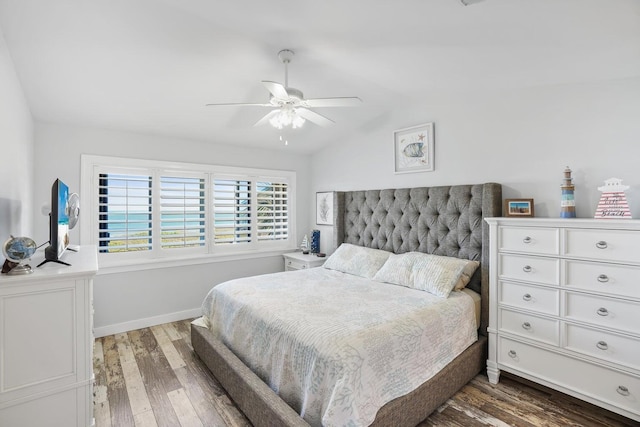 bedroom with ceiling fan, dark hardwood / wood-style flooring, and vaulted ceiling