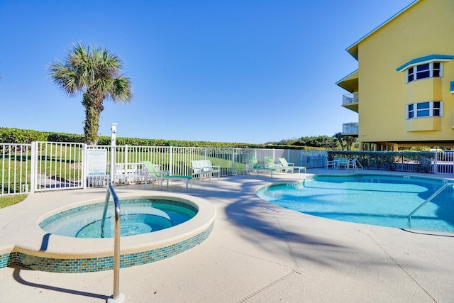 view of pool with a patio area and a community hot tub