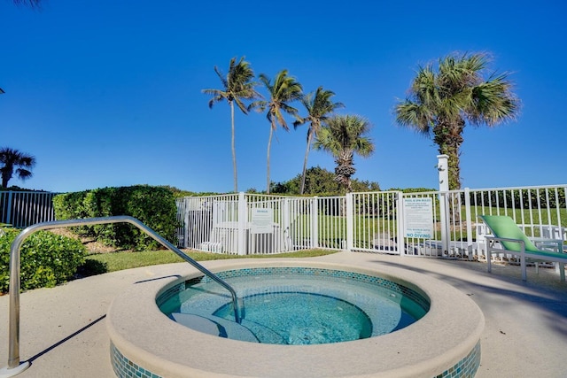 view of swimming pool with a hot tub