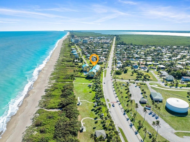 aerial view with a water view and a beach view