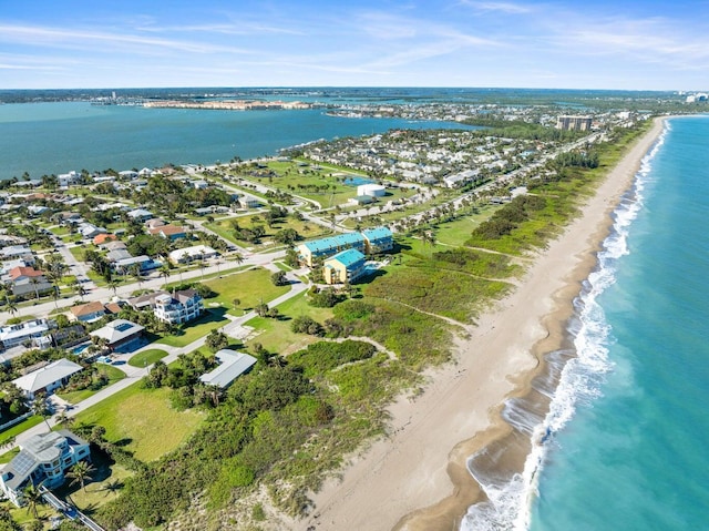 birds eye view of property with a beach view and a water view