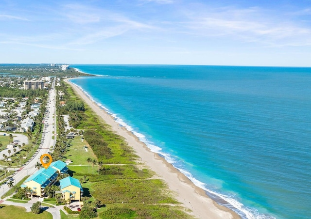 drone / aerial view featuring a water view and a beach view