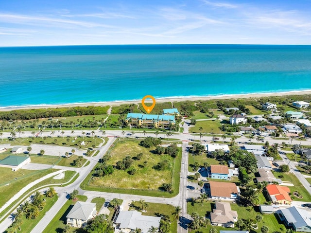 aerial view with a water view and a view of the beach