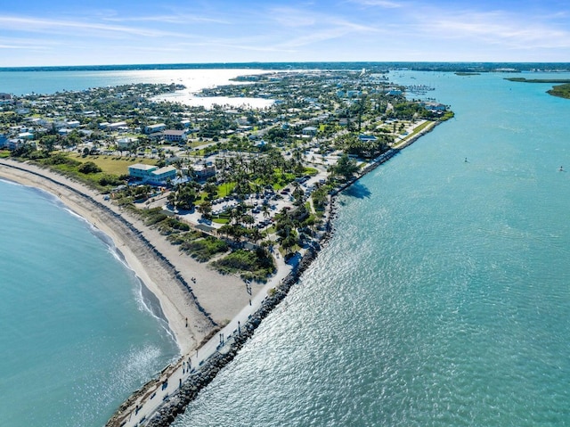 bird's eye view featuring a water view and a beach view