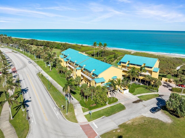 aerial view with a water view and a beach view