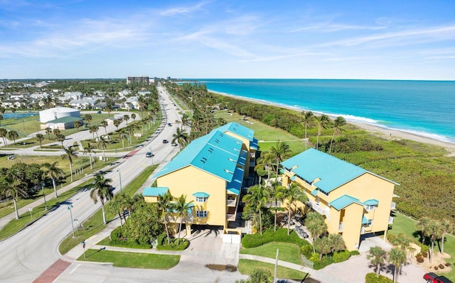 drone / aerial view with a beach view and a water view