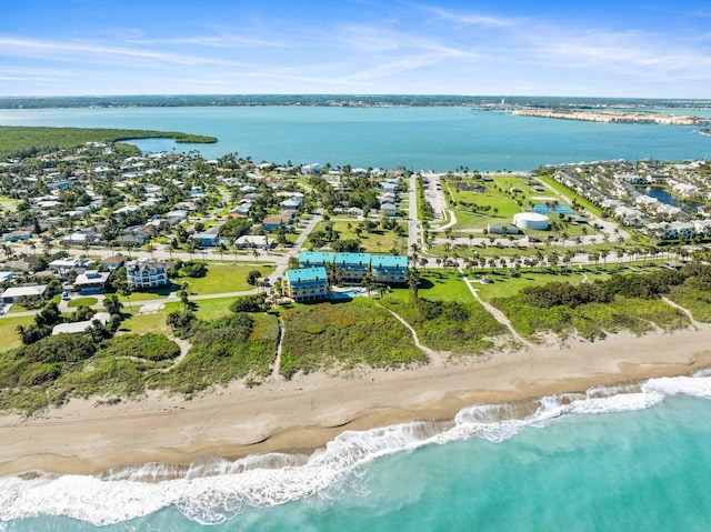 birds eye view of property featuring a view of the beach and a water view