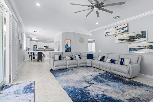 tiled living room with ceiling fan and ornamental molding