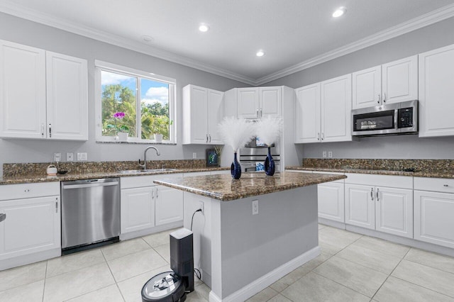 11158 Mainsail Ct, Wellington, FL 33449 - kitchen featuring appliances with stainless steel finishes, a sink, white cabinetry, dark stone countertops, and recessed lighting