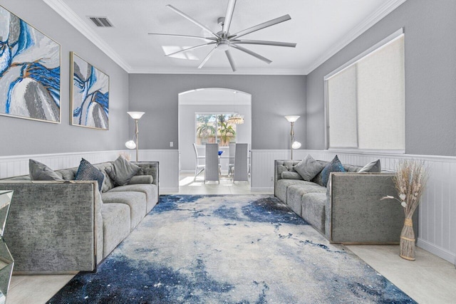 living room featuring ceiling fan and crown molding