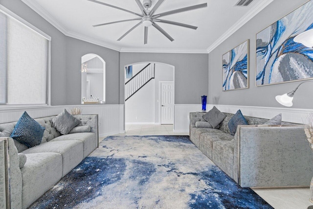 11158 Mainsail Ct, Wellington, FL 33449 - living room with arched walkways, ceiling fan, ornamental molding, a wainscoted wall, and stairway