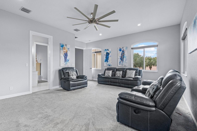 carpeted living room with ceiling fan