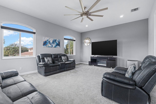 living room with light carpet and ceiling fan