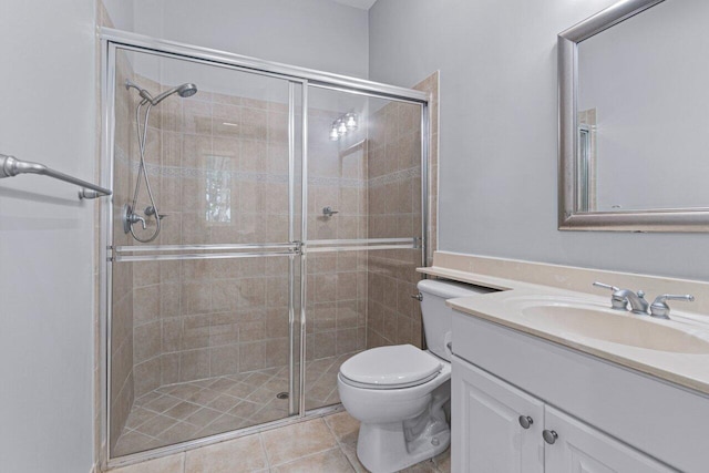 bathroom with tile patterned flooring, toilet, an enclosed shower, and vanity