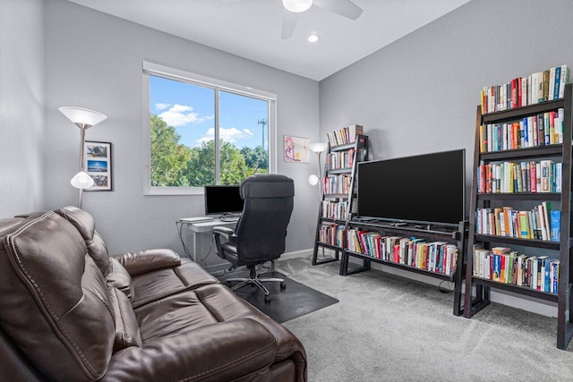 carpeted home office featuring ceiling fan