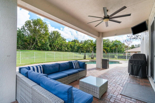 view of patio / terrace featuring an outdoor living space, ceiling fan, a fenced in pool, and grilling area