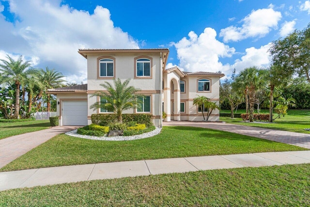 mediterranean / spanish-style house featuring a front yard and a garage