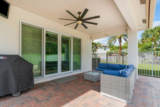 view of patio featuring an outdoor living space, area for grilling, and ceiling fan