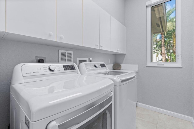 11158 Mainsail Ct, Wellington, FL 33449 - washroom featuring washing machine and dryer, cabinet space, healthy amount of natural light, and baseboards