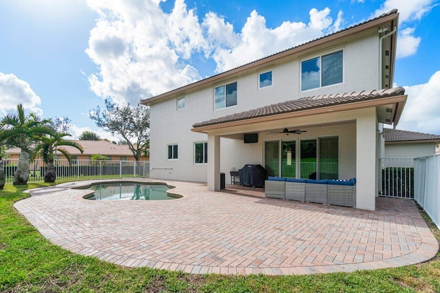 back of house with ceiling fan, a fenced in pool, an outdoor hangout area, and a patio