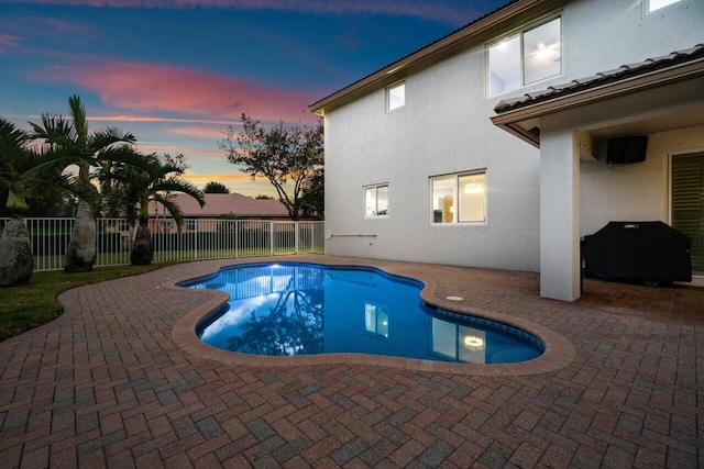 view of pool with a patio area and a grill