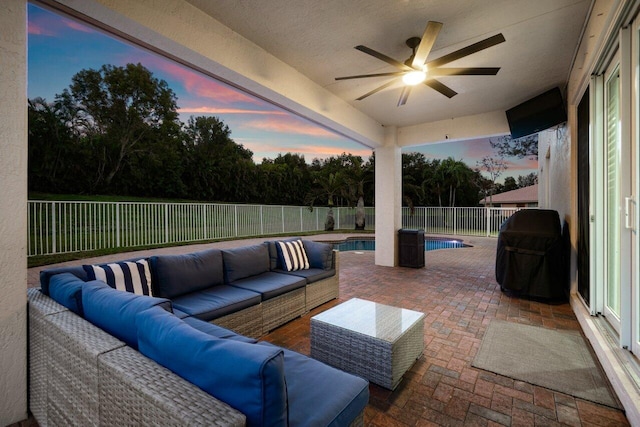 view of patio featuring outdoor lounge area, ceiling fan, and a fenced in pool