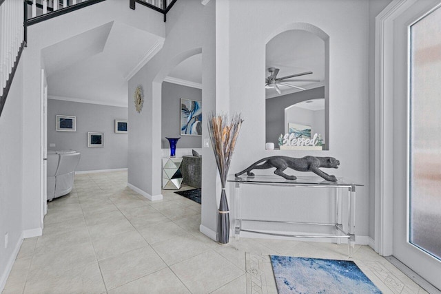 hall featuring washing machine and dryer, crown molding, and light tile patterned floors